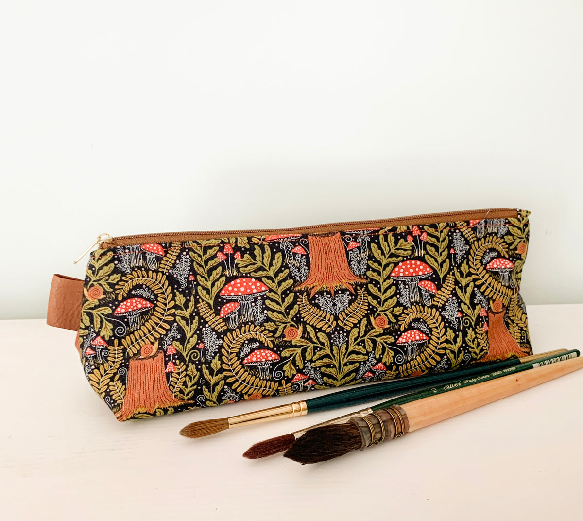 Artist supply brush case with forest fabric print