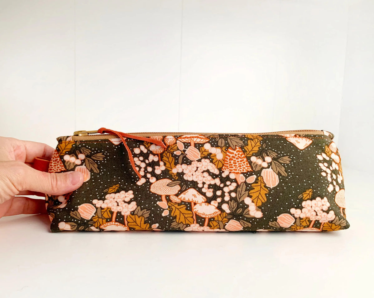 Artist brush case with autumn mushrooms print.